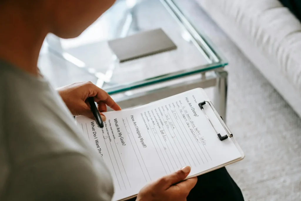 a person holding a clipboard with a pen